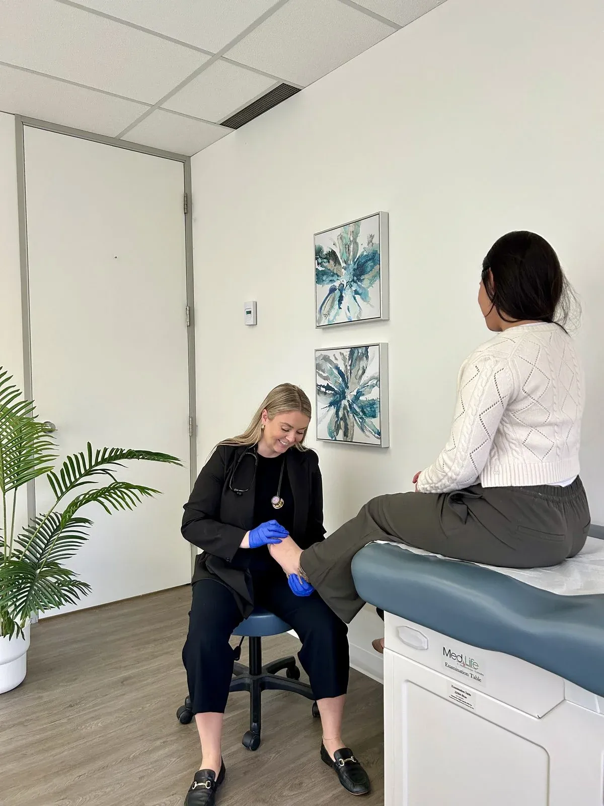 Nurse Practitioner providing care in a comfortable exam room at Care&